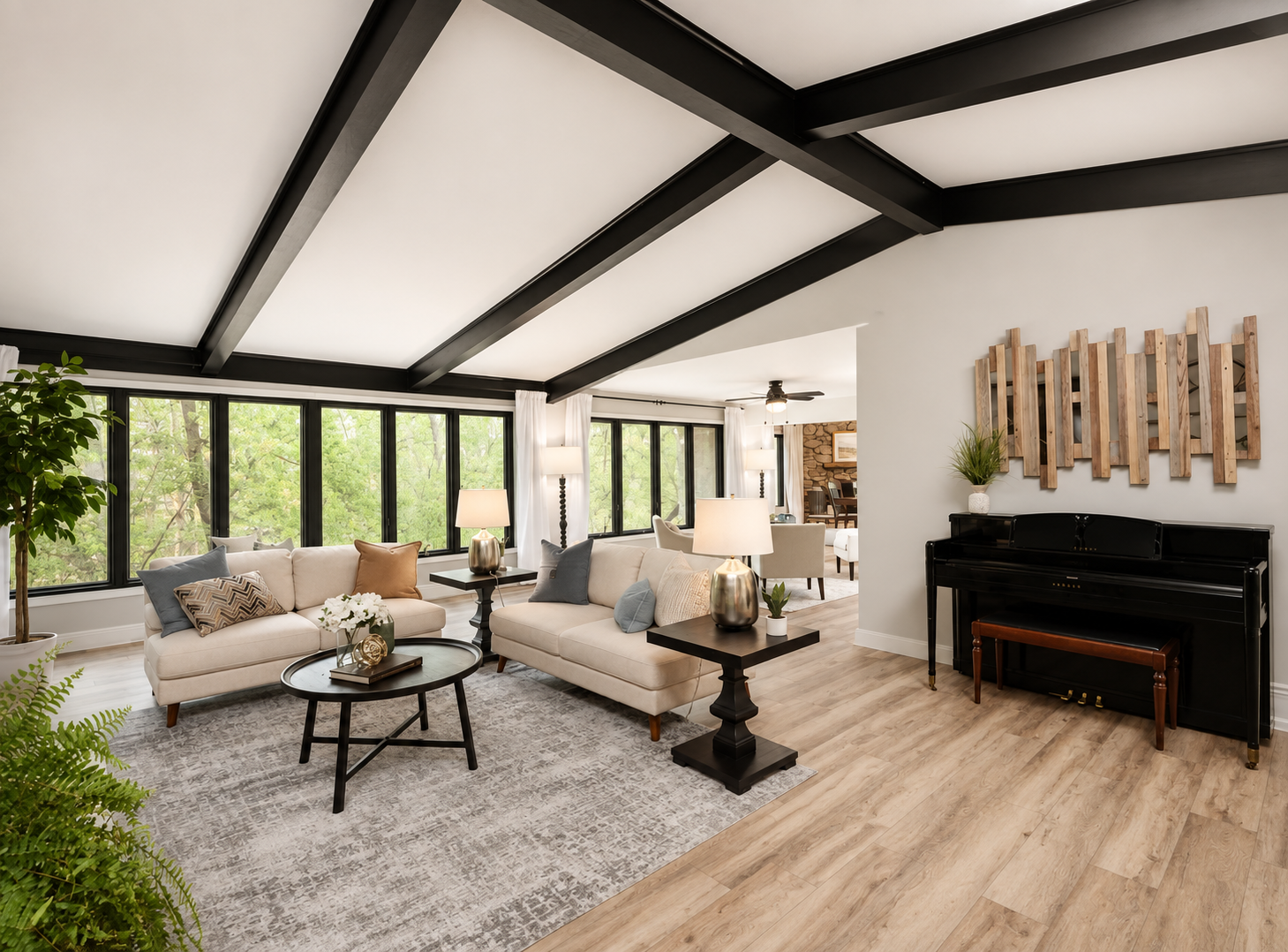 Vaulted living room with white ceiling and black painted beams