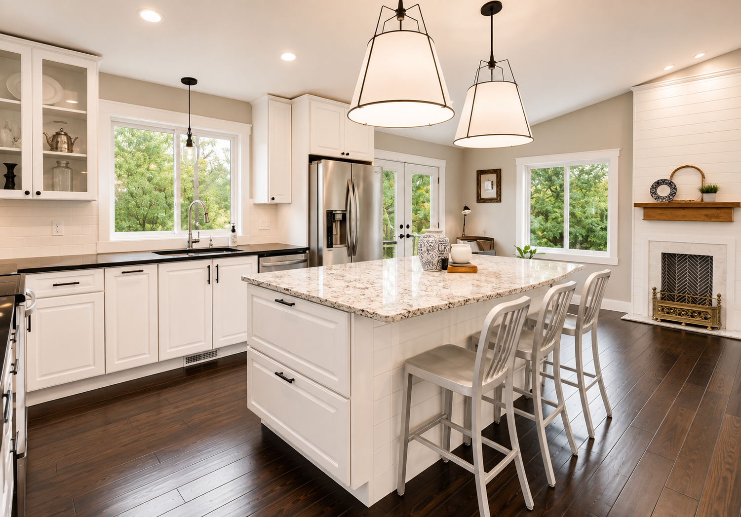 Open concept kitchen with white cabinets and warm greige walls