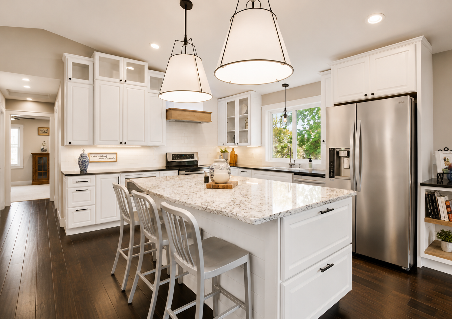 Bright kitchen with white painted cabinets and a granite island