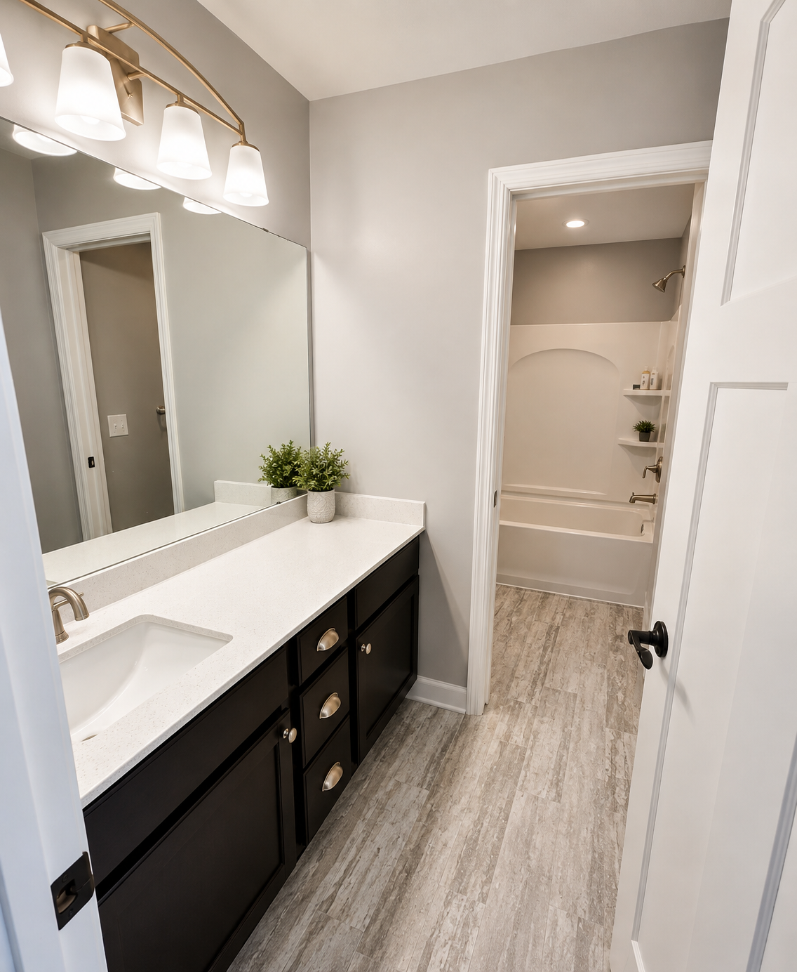 Bathroom vanity refinished in black with light gray walls