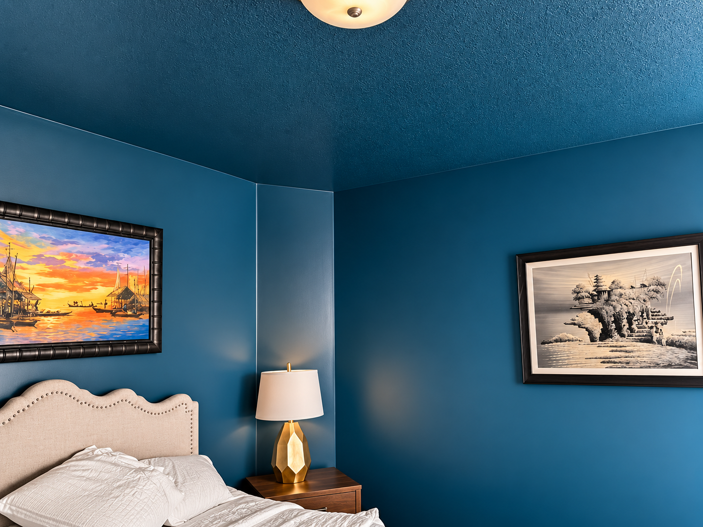 Bedroom painted in deep blue including the ceiling